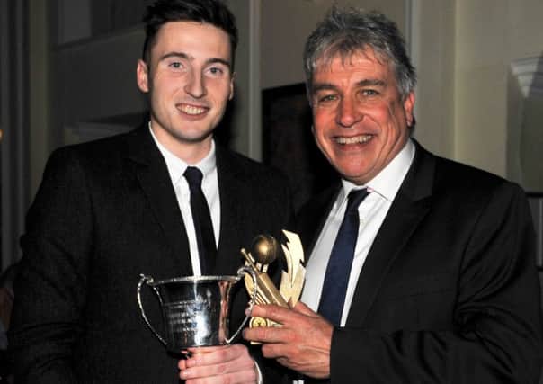 Sleaford's Tom Shorthouse (left) receives the Stephen Bradford Memorial Award for the best all rounder from BBC broadcaster John Inverdale at the ECB presentation night at Hemswell Court. Photo: Nigel West