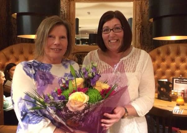 Judy Chapman of Skegness Partnership presents a bouquet to town centre manager  Lisa Colllins to wish her luck in her new job. ANL-160503-175335001