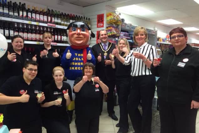 Retail apprentice Whitney Eldred (front left) with (from second right) area manager Anne Howard, store manager Jenny Hunt, Mayor Carl Masey, the Jolly Fisherman and other members of staff at the Savers relaunch. ANL-160503-132459001