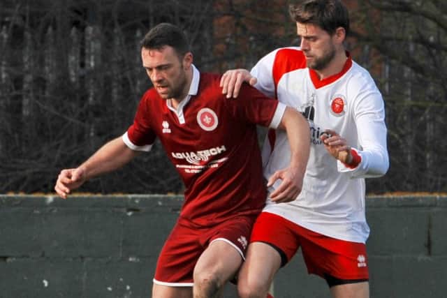 Skegness Town defender Liam Parker closes down Lincoln Railway goalscorer Liam Bradley.