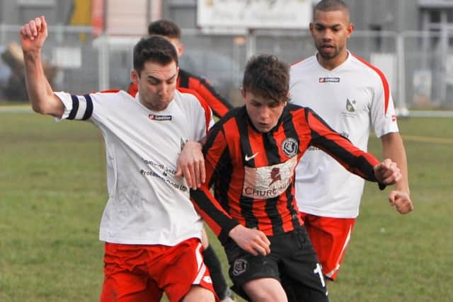 Skegness United's George Hobbins (right) under pressure from Rasen skipper Joe Osbourne.
