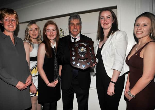 Just champion! Market Rasen Women's cricketers are seen receiving their Lincolnshire championship trophy from sports journalist and broadcaster John Inverdale. From left are Catherine Fussey, Rebecca Brooker, Megan Quinlan, Bethany Smith and Niamh Skipworth.