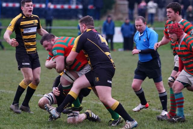 Ollie Cole is brought to a halt at Derby.