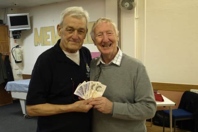 John Monk (MBE) and Bob Dawes receiving the money.