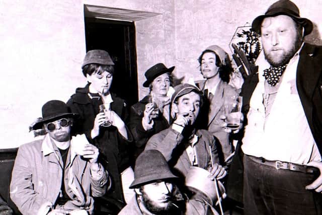 Time for supper, some of the tramps get stuck into their sandwiches and ale at the Tramps' Supper held at The Plough Inn, Wilsford in 1967. EMN-160303-115926001