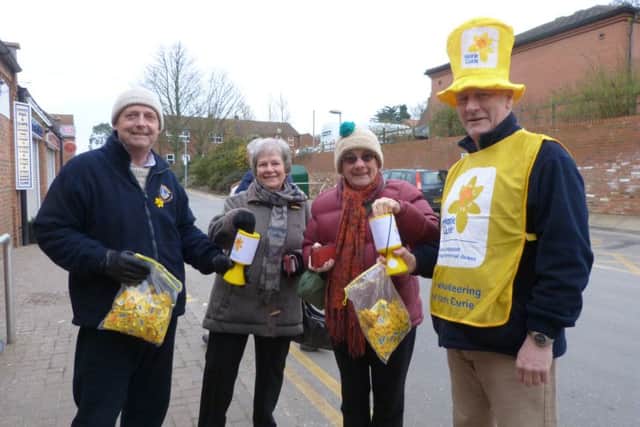 Putting their donations in the boxes are Linda Mason, left, and Ann Prestwood with Lions Martyn Kemp, left and Steve Webster outside the CoÂop. (Lin) EMN-160303-103207001