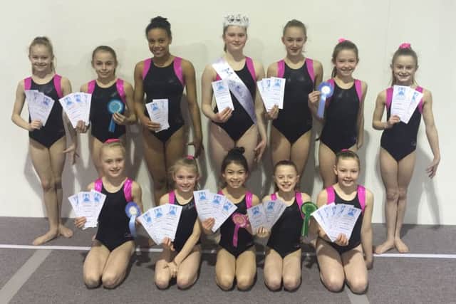 The girls (except Kenzie Burrell) proudly displaying their various apparatus awards, rosettes and the important crown and sash.