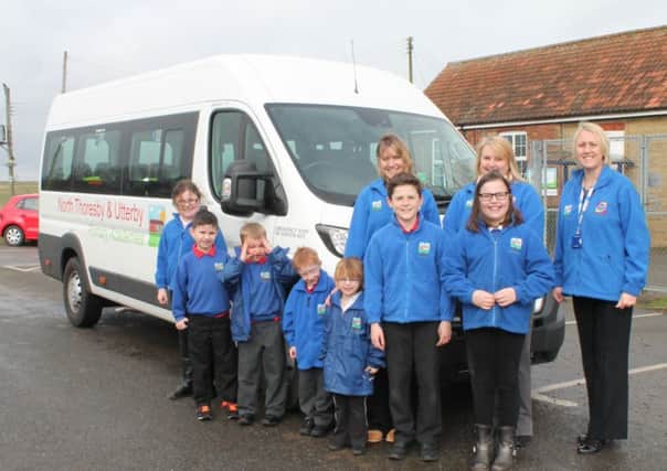 Staff and pupils at Utterby Primary School with their new minibus.