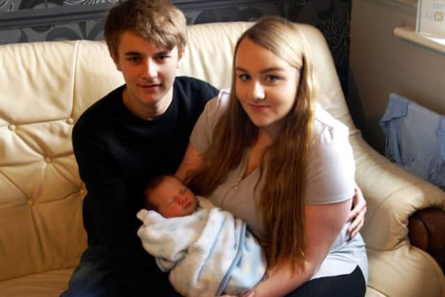 New parents Jack Coddington and Lauren Tindall with their son Kyran.