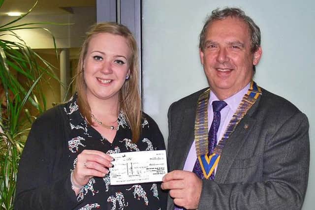 One of many cheque presentations as Brigg Rotary President Nick Wells, presents a cheque for ?875 to Lauren Alexander, during an inspirational visit to St. Andrew's Hospice to view their new facilities. EMN-160803-121657001