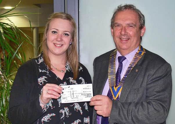 One of many cheque presentations as Brigg Rotary President Nick Wells, presents a cheque for ?875 to Lauren Alexander, during an inspirational visit to St. Andrew's Hospice to view their new facilities. EMN-160803-121657001