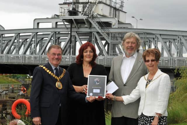 Jenny and Tom Rowe received the Couple of the Year Award in the shadow of Cross Keys Swing Bridge, Sutton Bridge,from Lincolnshire County Council chairman Coun William Webb and his wife Jane. Photo by Tim Wilson.