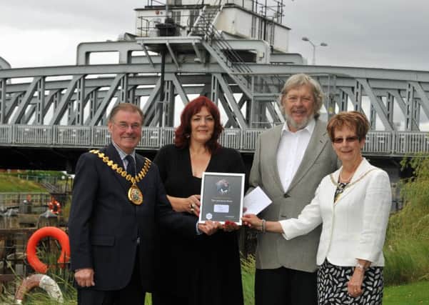 Jenny and Tom Rowe received the Couple of the Year Award in the shadow of Cross Keys Swing Bridge, Sutton Bridge,from Lincolnshire County Council chairman Coun William Webb and his wife Jane.  Photo by Tim Wilson.