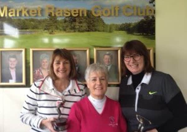 The winners of the Winter League collect the trophy from captain Helen Ginham. Pictured, from left, are Bridget Holmes, Helen Grinham and Aileen Sellers.