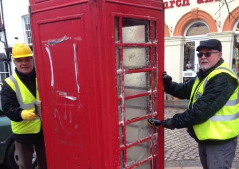 Lions members clean up the phone box in the Market Place EMN-160903-110327001