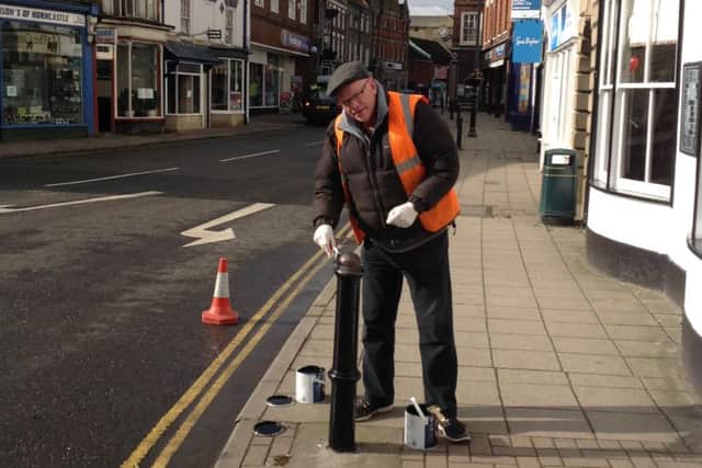 Councillor Phil Cantwell gets to grips with a bollard outside the Red Lion EMN-160903-110304001