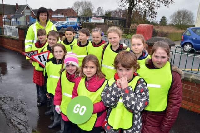 Youngsters at Gosberton Academy learn about road safety with Kay Tayman (back left) of Lincolnshire Road Safety Partnership. Photo by Tim Wilson.