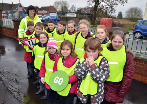 Youngsters at Gosberton Academy learn about road safety with Kay Tayman (back left) of Lincolnshire Road Safety Partnership.  Photo by Tim Wilson.
