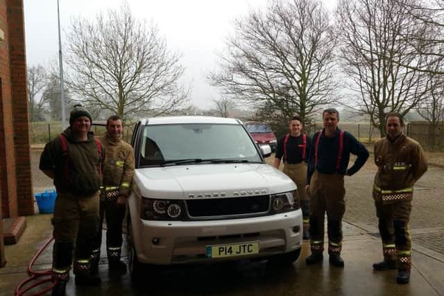 Billinghay firefighters keeping it clean for charity with their car wash on Saturday. EMN-160314-091426001