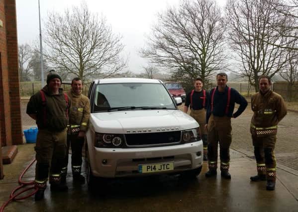 Billinghay firefighters keeping it clean for charity with their car wash on Saturday. EMN-160314-091426001