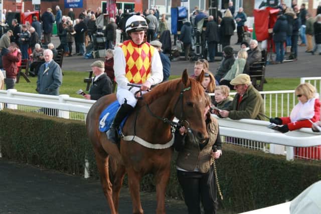 The Society Man, trained by Market Rasen's Michael Chapman, in the parade ring with jockey Graham Carson. EMN-160314-095715002