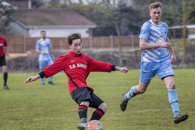 Coningsbys Andrew Chapman boots the ball that ended up in the Leverton net for his teams only goal in match play in the Sports Cup quarter-final on Saturday. Photo: Oscarpix Imaging.