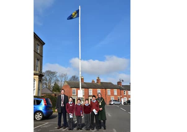 Hoisting the Commonwealth Flag for Commonwealth Day. From left - Coun Gill Odgen, NKDC Corporate Director Phil Roberts and William Alvey pupils Amelia Botto, Erin Clifford and Elliott Jackson from Year 5, and Jake Barnshaw of Year 6. EMN-160315-091918001