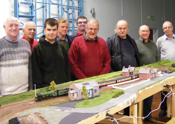 Members of Sleaford Model Railway Club with their latest lay-out. EMN-160320-134124001