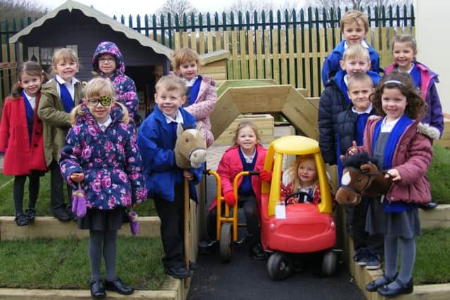 Class 1 (reception) children at Mrs Mary King's Primary School celebrate the completion of their refurbished outdoor play area. EMN-160318-164334001