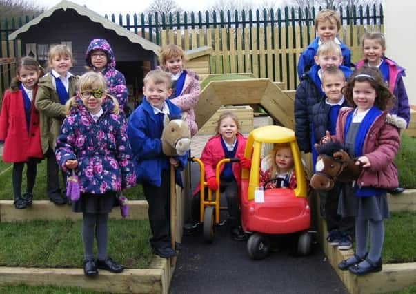 Class 1 (reception) children at Mrs Mary King's Primary School celebrate the completion of their refurbished outdoor play area. EMN-160318-164334001
