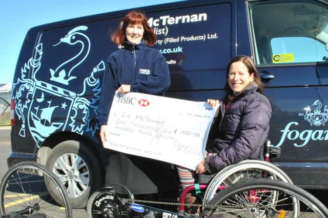 Liz McTernan receives a cheque from Christine Newitt, director at Duncan & Toplis, to help replace her badly-damaged race bike. EMN-160317-093612002