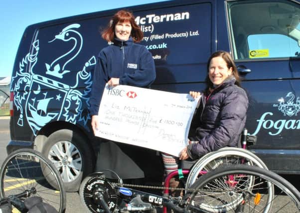 Liz McTernan receives a cheque from Christine Newitt, director at Duncan & Toplis, to help replace her badly-damaged race bike. EMN-160317-093612002