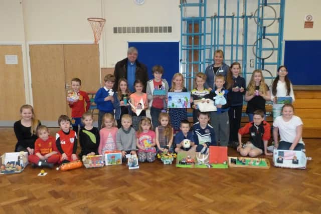 The Rev Canon Ian Robinson and headteacher Zoe Hyams with the winners of the decorated eggs. (Lin) EMN-160323-105651001