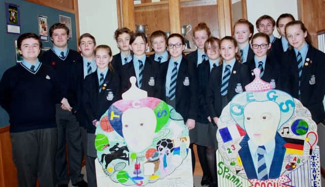 Some of the 16 pupils who took part in the production on the life of Queen Elizabeth I, with the two cut-outs.