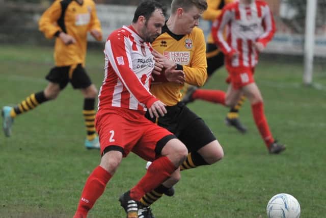 Horncastle Town's Steve Lovett (left) tussles with Skegness Town full back Jamie Epton. Photo: Nigel West