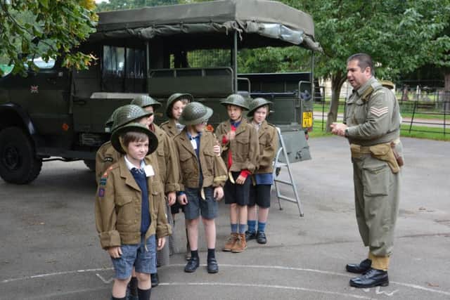 Paul Britchford takes youngsters through a World War II reenactment.