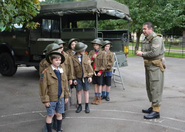 Paul Britchford takes youngsters through a World War II reenactment.