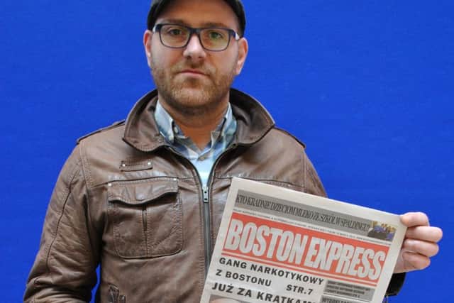 Boston Express editor Piotr Ozga with his first printed edition. ANL-160323-093943001