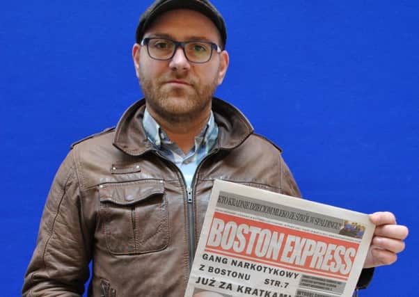 Boston Express editor Piotr Ozga with his first printed edition. ANL-160323-093943001