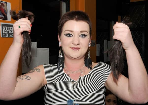 Chloe Sands having her hair cut off for charity, at Axe & Cleaver, Boston. Sammi Barsley cutting hair.