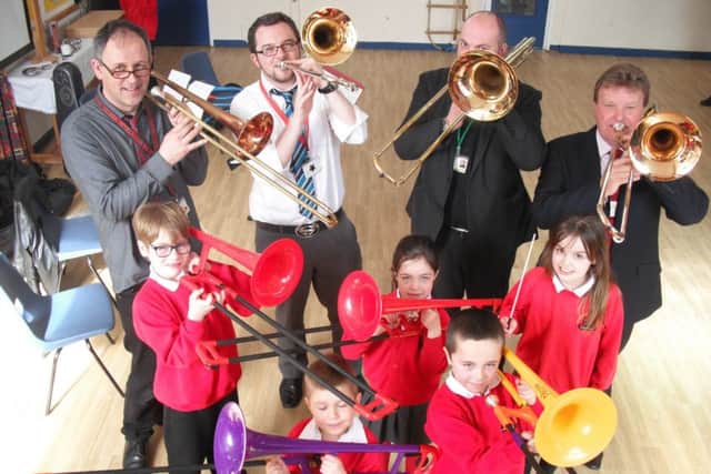Children at St Andrew's Primary School enjoy some musical fun with the trombone quartet