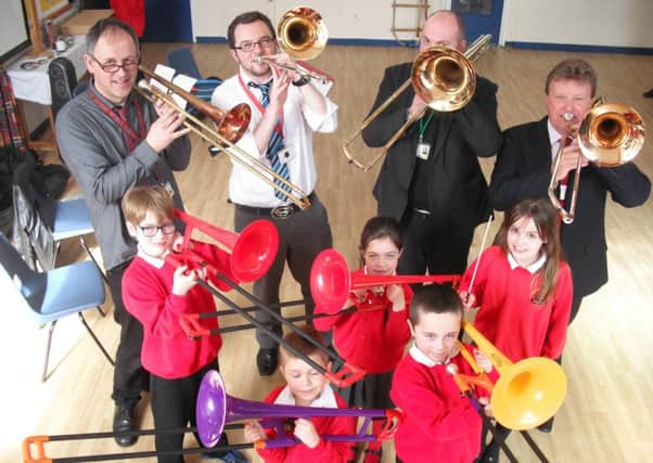 Children at St Andrew's Primary School enjoy some musical fun with the trombone quartet