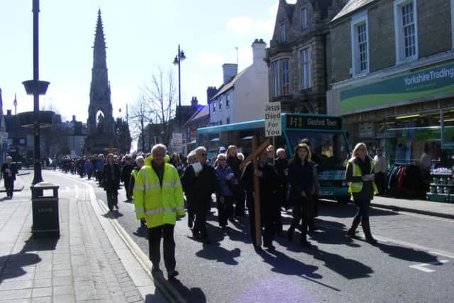 The Walk of Witness procession heads up Southgate in Sleaford today (Good Friday). EMN-160325-112003001