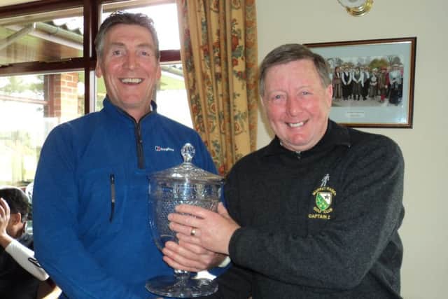 Vice-captain Gaff Elliott (left) presents trophy to skipper Les Brumpton EMN-160328-120238002