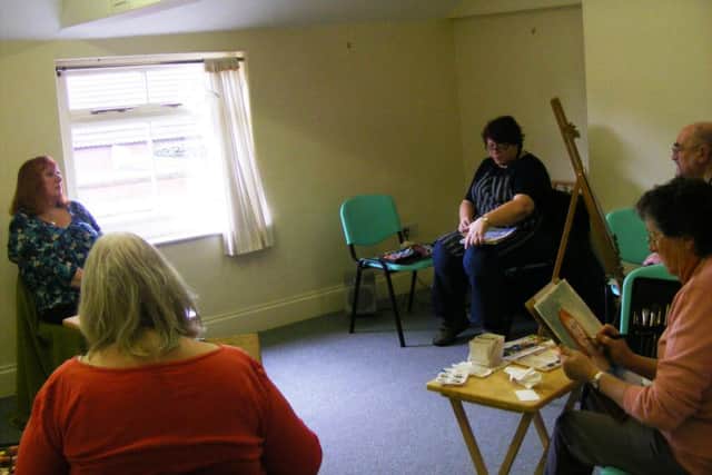 Artists at work on a portrait for the Sleaford Art Event Challenge. EMN-160328-151317001