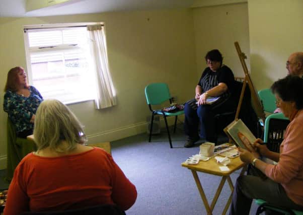 Artists at work on a portrait for the Sleaford Art Event Challenge. EMN-160328-151317001