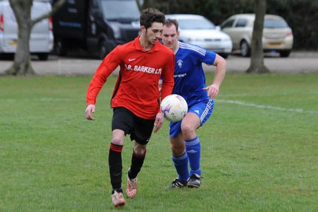 Fishtoft (blue), Coningsby (red) football action. John McGarel (blue), Shaun Boothby (red).