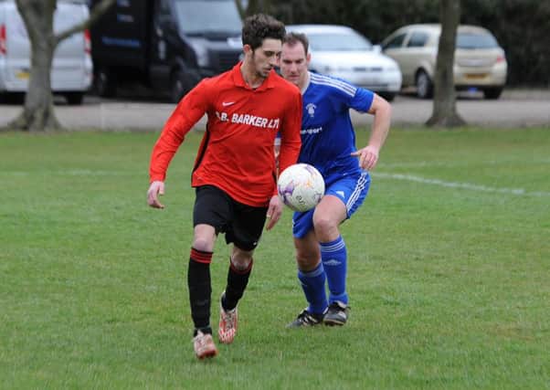 Fishtoft (blue), Coningsby (red) football action. John McGarel (blue), Shaun Boothby (red).