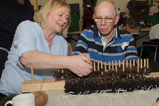 Woolly day at North Kyme Village Hall, organised by South Lincolnshire Spinner and Weavers. Jane Brewin (member) making a rug with Rick Oliver. EMN-160330-174354001