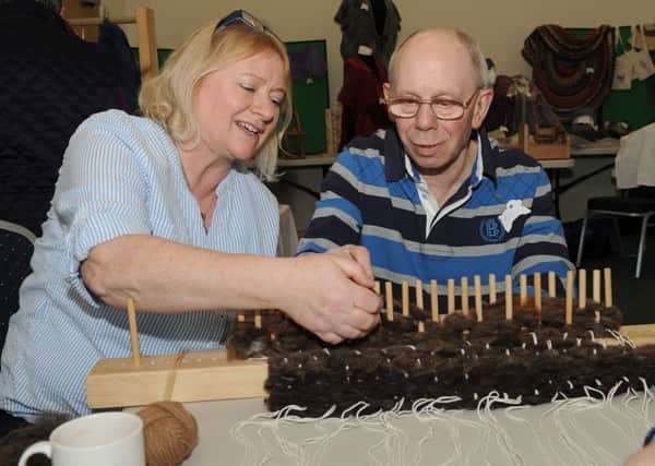 Woolly day at North Kyme Village Hall, organised by South Lincolnshire Spinner and Weavers. Jane Brewin (member) making a rug with Rick Oliver. EMN-160330-174354001